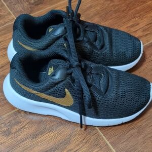 Nike Kids Black Sneakers with Gold Accents